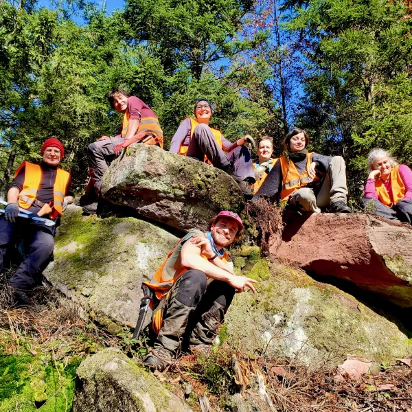 Freiwilligen vereint im Gruppenbild in Steinblöcken