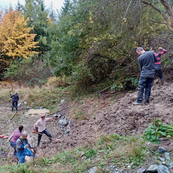 Menschen stehen verteilt an einem Abhang