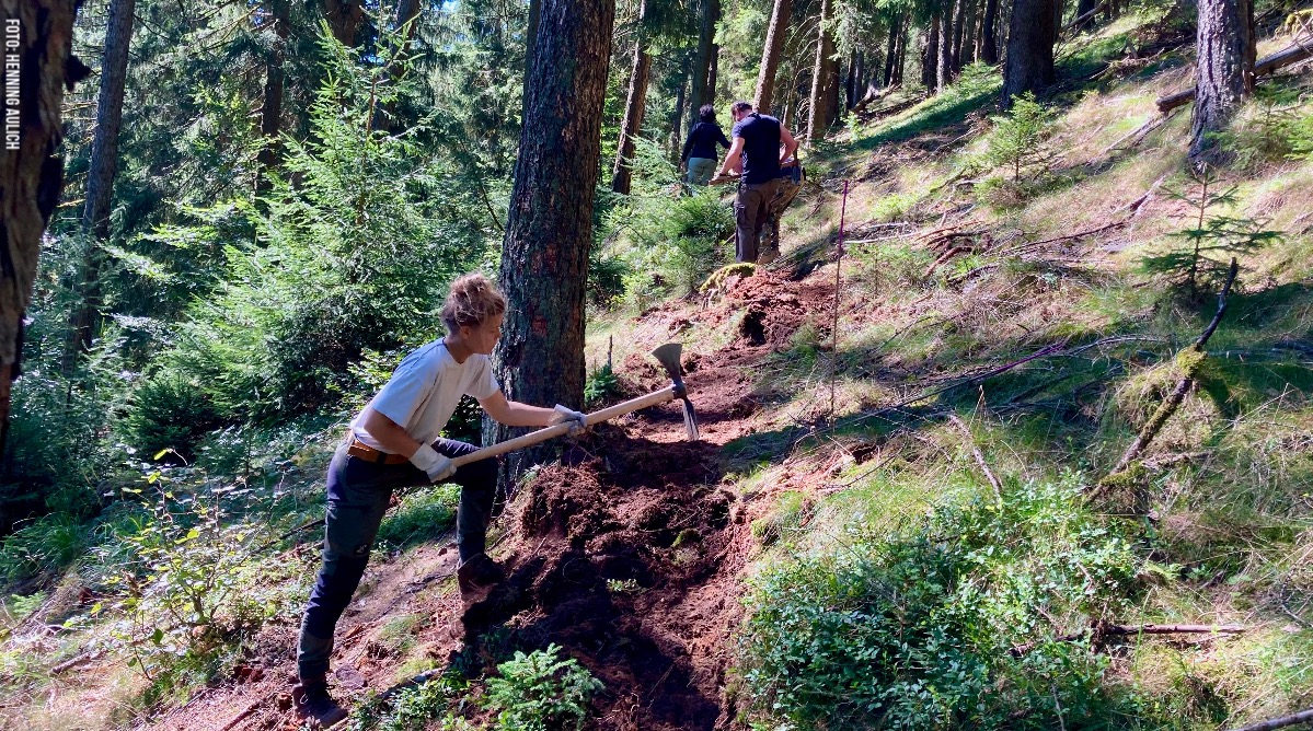 Menschen hacken einen Pfad in den Hang Menschen hacken einen Pfad in den Hang